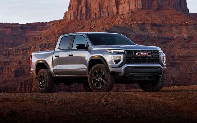 2024 GMC Canyon Photograph in front of a vast canyon